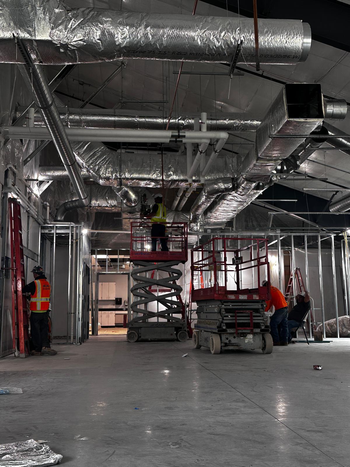 Crews installing overhead systems during MPaCT Lab renovation